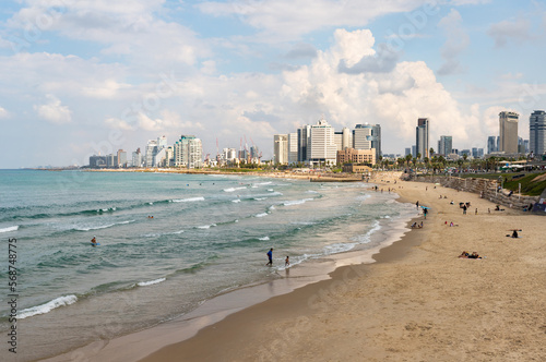 Promenade and free beach in the old town of Yafo and the skyscrapers of Tel Aviv in the distance, in Tel Aviv - Yafo city, Israel © svarshik