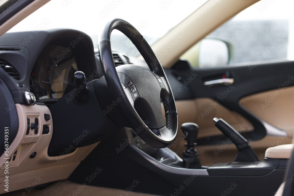 interior of a car with a bright interior and a manual transmission with a raised handbrake