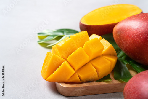 Obraz na płótnie Mango background design concept. Top view Diced fresh mango fruit on white table.