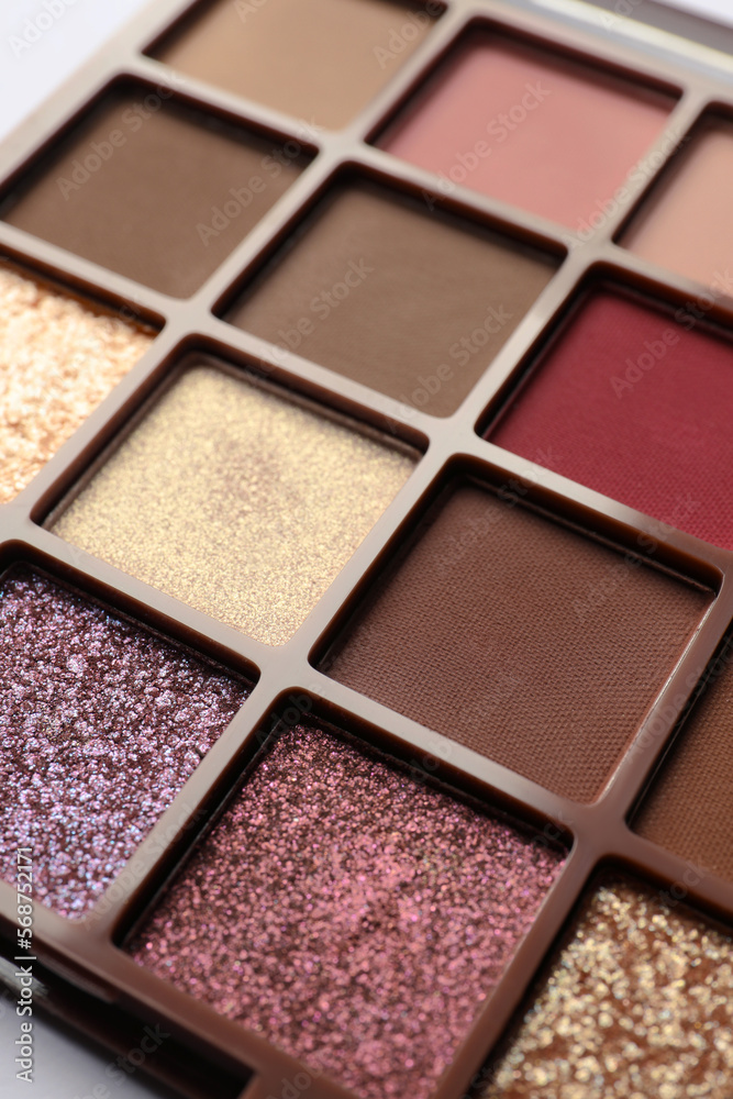 Fototapeta premium Beautiful eye shadow palette on white table, closeup