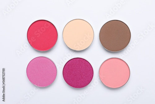 Beautiful eye shadow refill pans on white background, flat lay