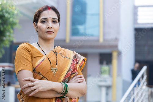 Confident Asian female looking at camera with folded hands. photo