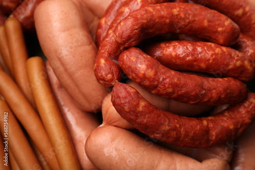 Different tasty sausages as background, closeup view
