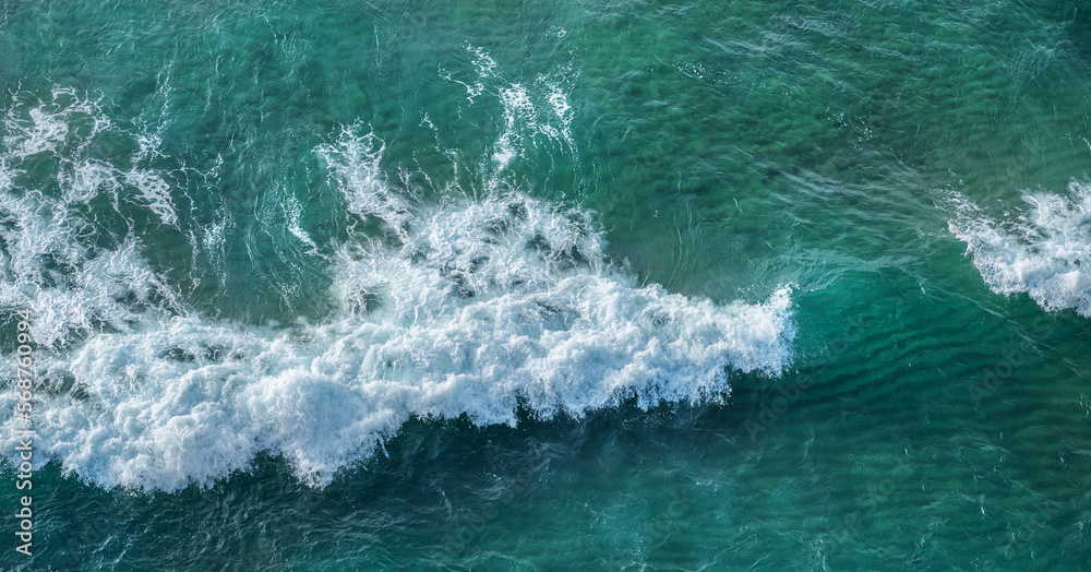 Ocean foamy waves approaching rocky shore. Top view. Ocean foamy waves approaching rocky shore. Top view.