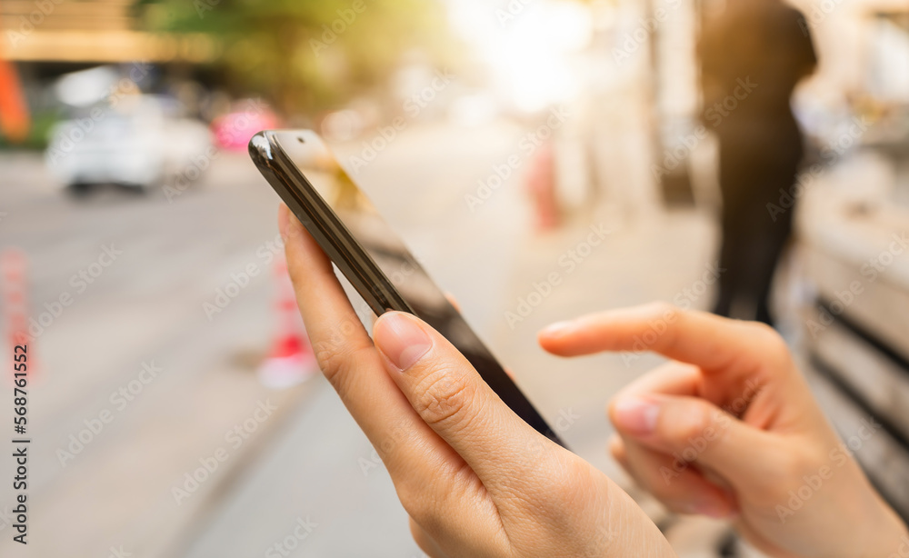 woman using smartphone in public areas, During leisure time. The concept of using the phone is essential in everyday life.