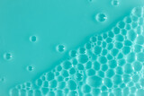 Bubble mint turquoise background texture. Berry gel to cleanse the skin of the face and body. Spa treatments, skin care. Bath foam, detergent. Slime blue