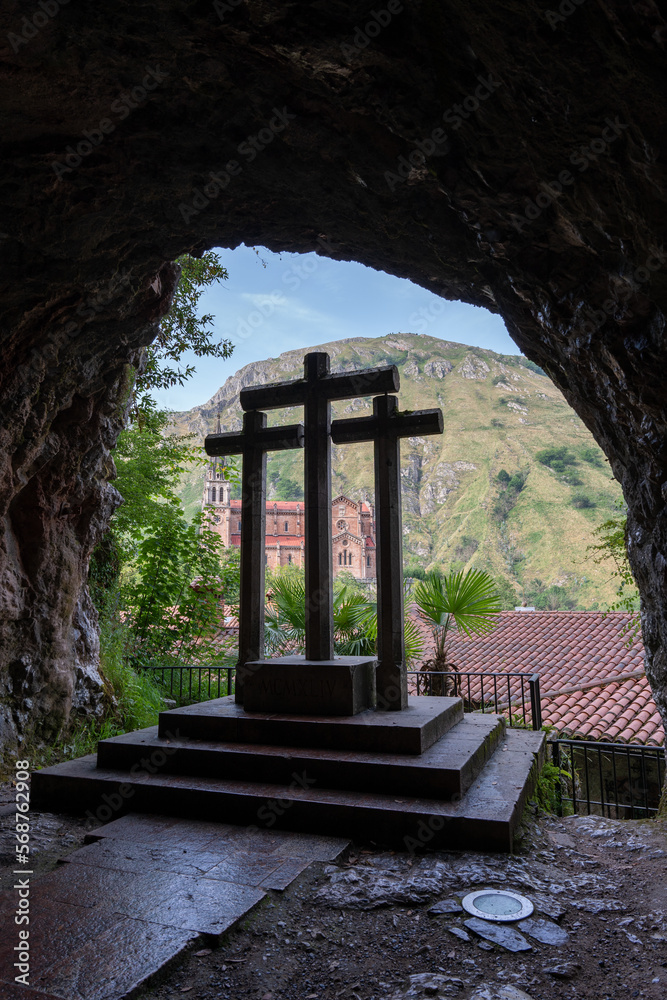 Crosses inside the sacred grotto of Covadonga in the Picos de Europa Natural Park in Asturias. Spain. With the background of the Sanctuary of Covadonga.