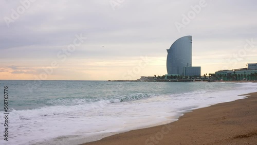 View of the Barceloneta beach with luxury hotel W Barcelona by the sea shore. Beautiful luxury hotel in Barcelona. photo