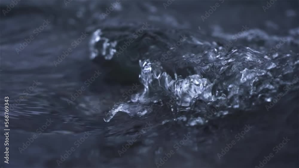 Water flow in mountain stream river dark background slow motion Water flow in mountain stream river dark background slow motion