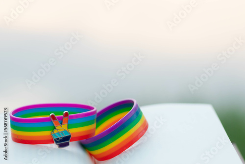 rainbow wristband is symbol for lgbtq or lgbtqia groups that unite to advocate for rights of LGBTQ people to have rights and freedoms in society and use colorful rainbow as symbol of lgbtq