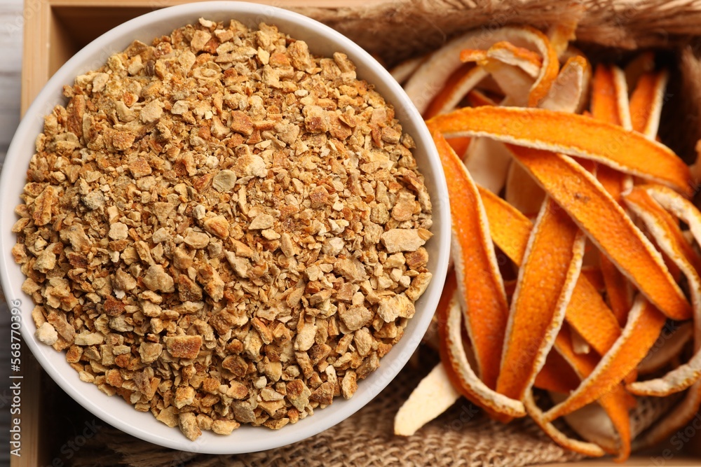 Dried orange seasoning zest and peel in box, top view Dried orange seasoning zest and peel in box, top view