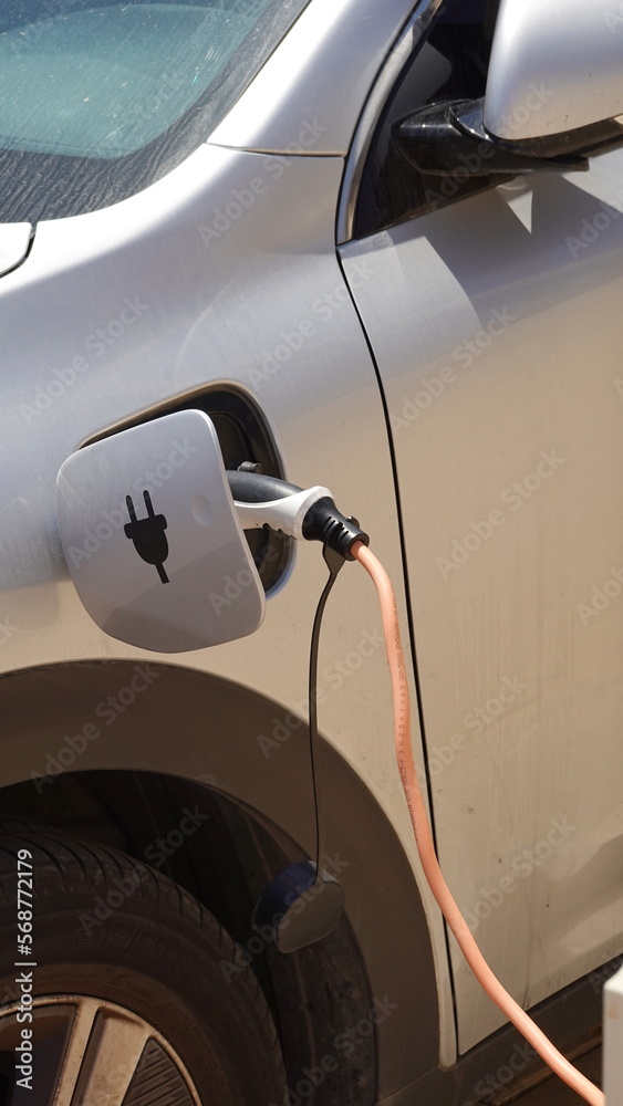 The process of charging an electric car. Rosette close-up
