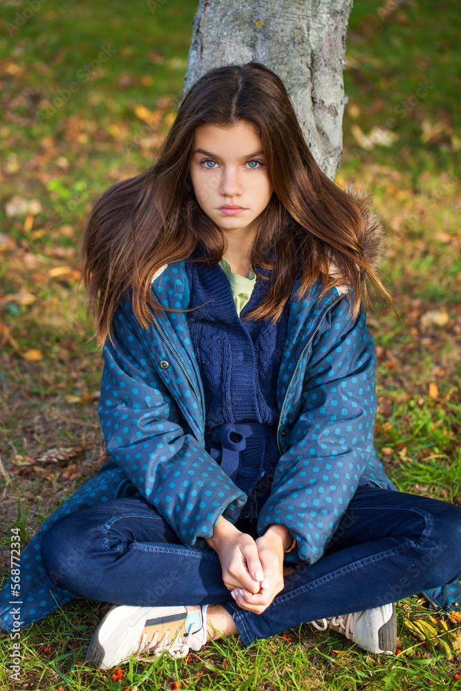 Portrait of young teenage girl lying in autumn foliage Portrait of young teenage girl lying in autumn foliage