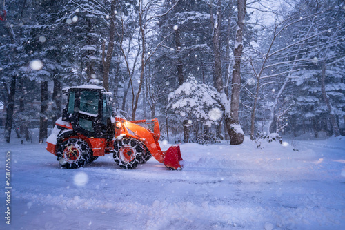 snow shovel tractor on a heavy snowy day at Heike No Sato Village in Tochigi Prefecture, Nikko City, JAPAN