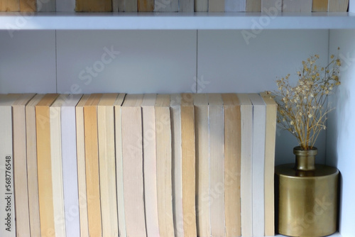 Bookshelf with books turned backwards and minimal decorations.