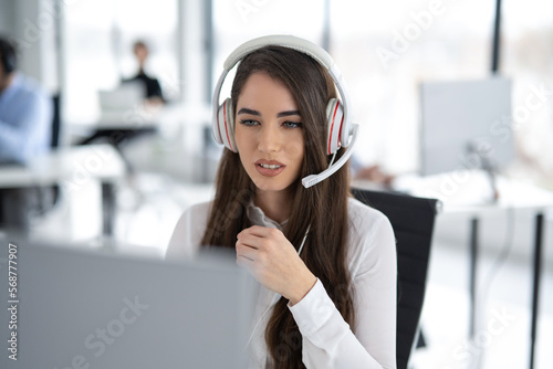Portrait of dedicated female operator agent working at IT support sector