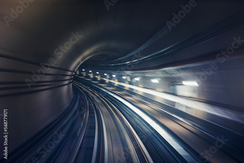 Railroad track in underground tunnel in blurred motion. Point of view from train. 