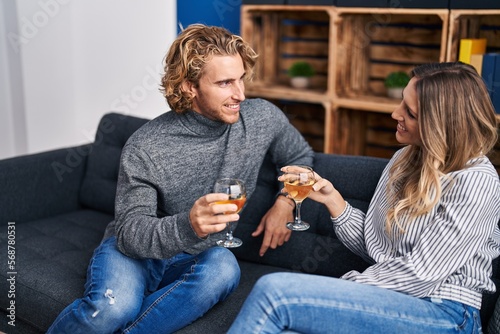 Man and woman couple smiling confident toasting with glass of champagne at home