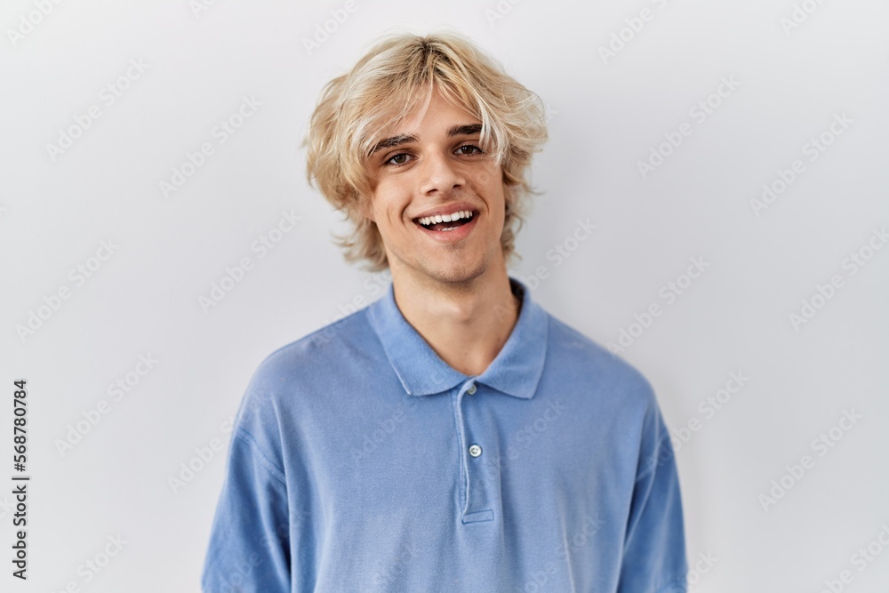 Young modern man standing over isolated background with a happy and cool smile on face. lucky person. Young modern man standing over isolated background with a happy and cool smile on face. lucky person.