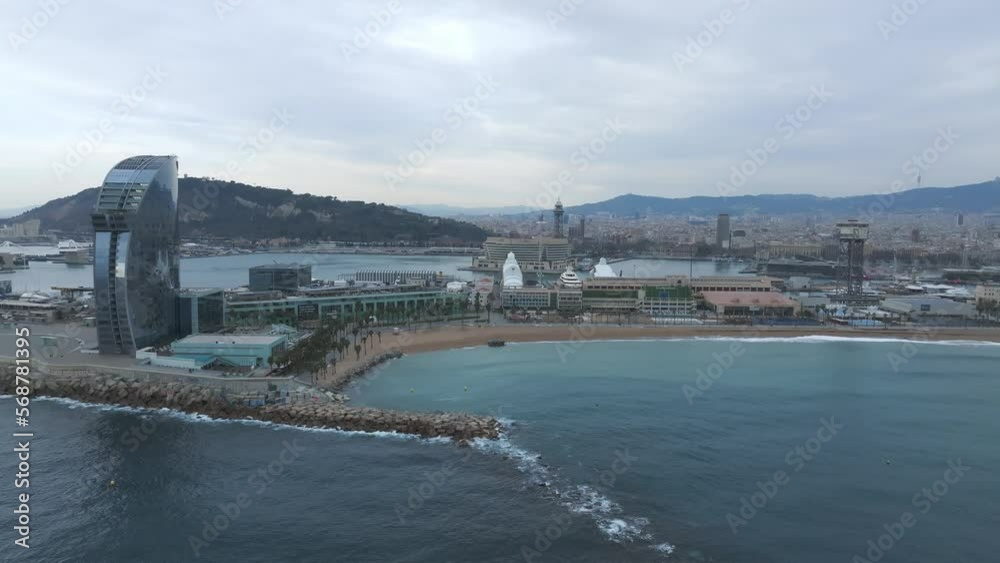 View of the Barceloneta beach with luxury hotel W Barcelona by the sea shore. Beautiful luxury hotel in Barcelona. View of the Barceloneta beach with luxury hotel W Barcelona by the sea shore. Beautiful luxury hotel in Barcelona.