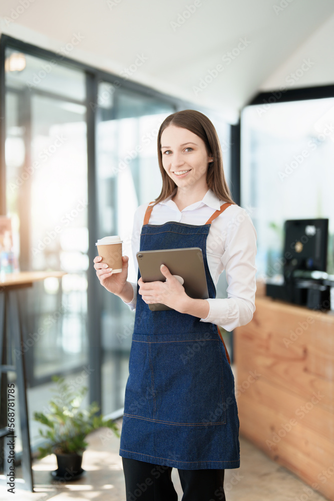 Starting and opening a small business, a young Asian woman showing a smiling face in an apron standing in front of a coffee shop bar counter. Business Owner, Restaurant, Barista, Cafe, Online SME
