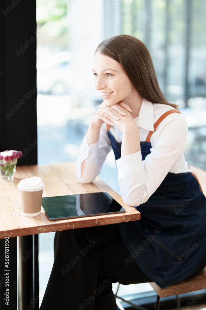 Starting and opening a small business, a young Asian woman showing a smiling face in an apron standing in front of a coffee shop bar counter. Business Owner, Restaurant, Barista, Cafe, Online SME Starting and opening a small business, a young Asian woman showing a smiling face in an apron standing in front of a coffee shop bar counter. Business Owner, Restaurant, Barista, Cafe, Online SME