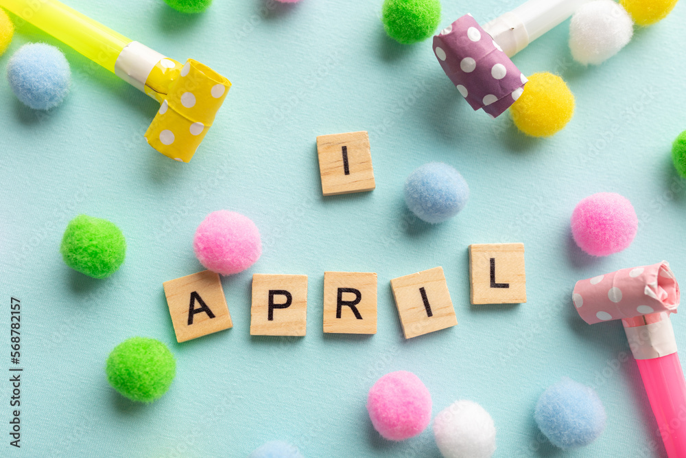 April 1st. Image of text April 1 and festive decor on the blue background. April Fool's Day April 1st. Image of text April 1 and festive decor on the blue background. April Fool's Day