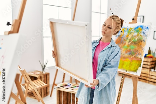 Young caucasian woman artist looking draw at art studio
