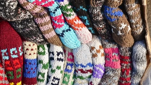 Close up traditional beautiful colorful hand-made socks for sale on display outside on babushkas stall photo