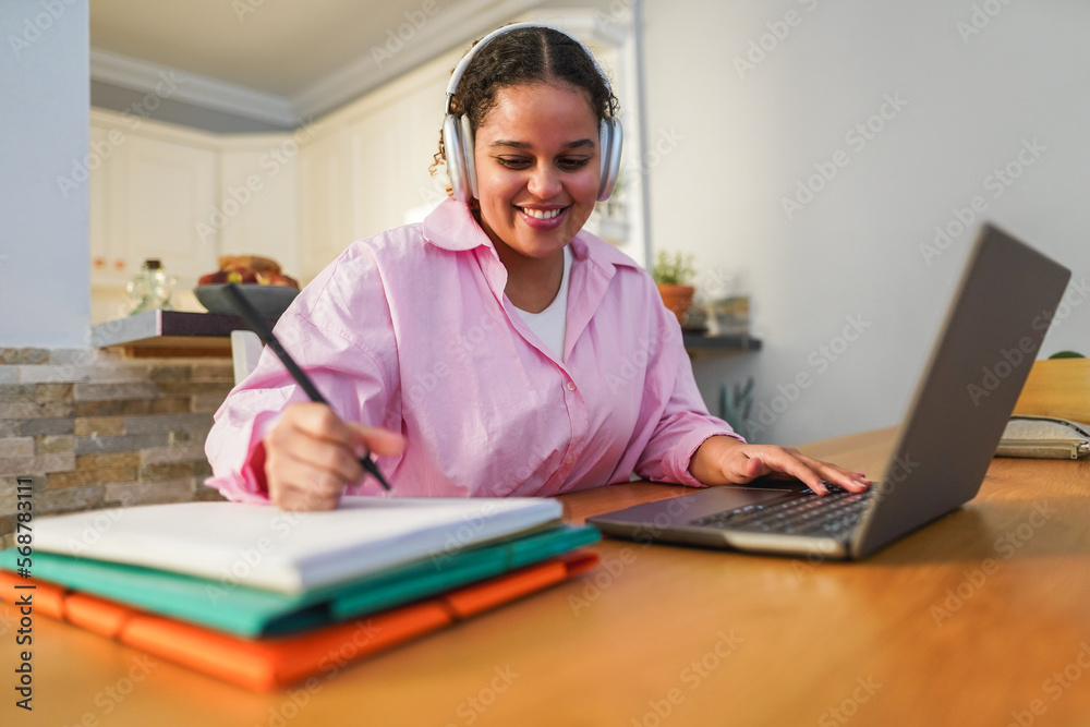 Girl using laptop computer from home while working on university project - Soft focus on face Girl using laptop computer from home while working on university project - Soft focus on face