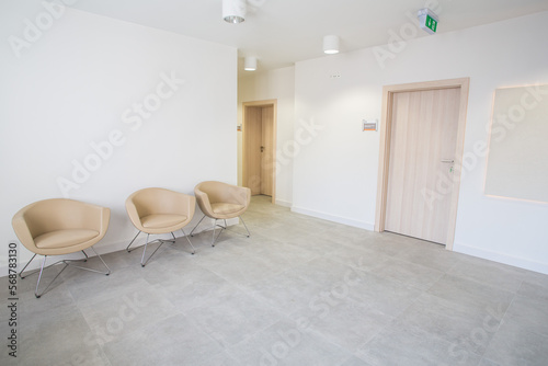 An elegant waiting room in a modern medical facility. Clinic with white walls and comfortable armchairs. Prestigious waiting room. Aesthetic medicine. Private offices.