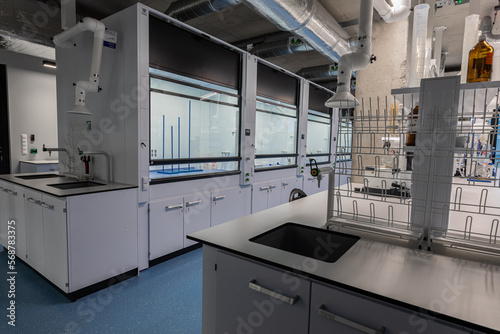 Chemical laboratory. White cabinets. Vials with chemicals. Chemists workplace. The interior of the studio.