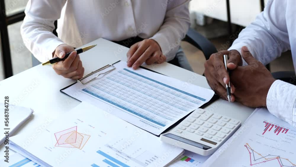 Accounting team manager working with cash flow chart and balance sheet, asset paperwork with stock market monthly statics Accounting team manager working with cash flow chart and balance sheet, asset paperwork with stock market monthly statics