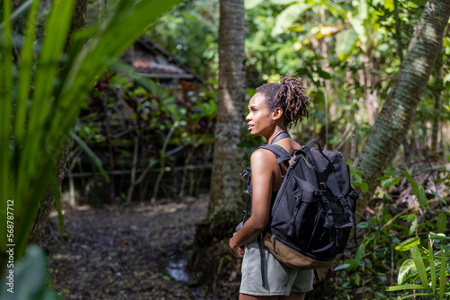 Indonesia, Bali, Female tourist hiking in rainforest