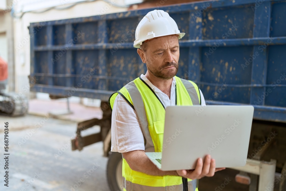 Middle age man architect using laptop at street Middle age man architect using laptop at street