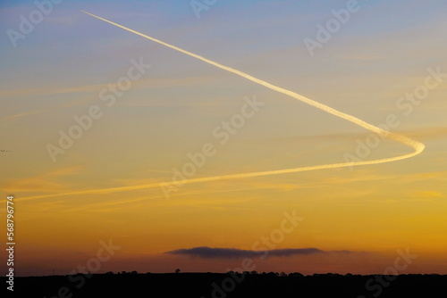 Sunset sky with plane vapour trail