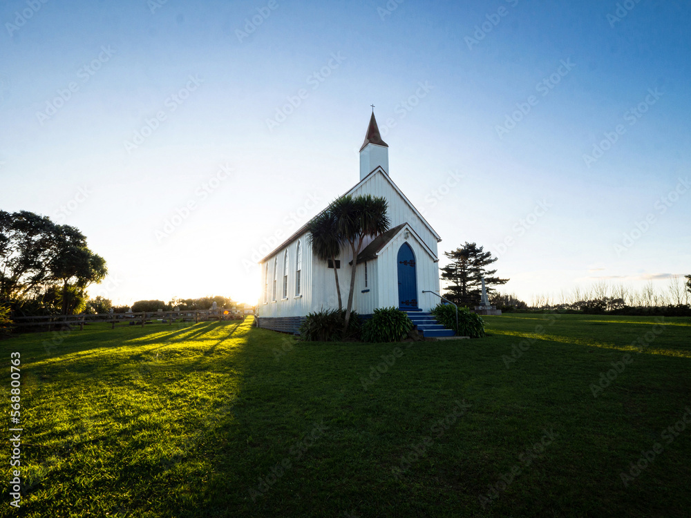 Fototapeta premium Old historic 19th century white presbyterian Awhitu Central Church with green grass, Manukau Heads Auckland New Zealand