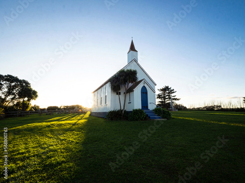 Old historic 19th century white presbyterian Awhitu Central Church with green grass, Manukau Heads Auckland New Zealand photo