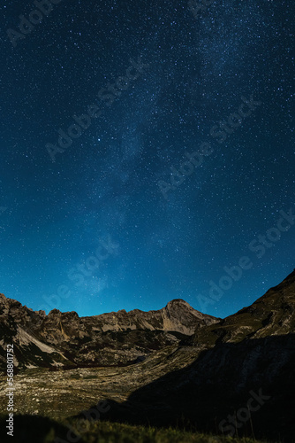 Vertical photo of the starry sky in a mountainous area. The Milky Way. Night photography without noise