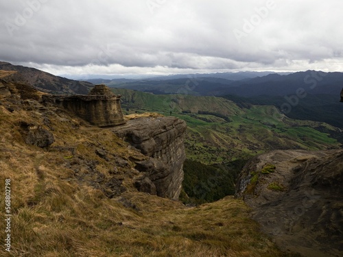 Lone hiker enjoying backcountry nature landscape mountain panorama at Bell Rock lookout in Tutira Hawkes Bay New Zealand