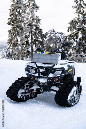  snowmobile are ready for adventure ride. Vehicle parked in line near beautiful forest in Lapland, Finland. Heavy snow. Winter seasonal landscape.  © dvv1989