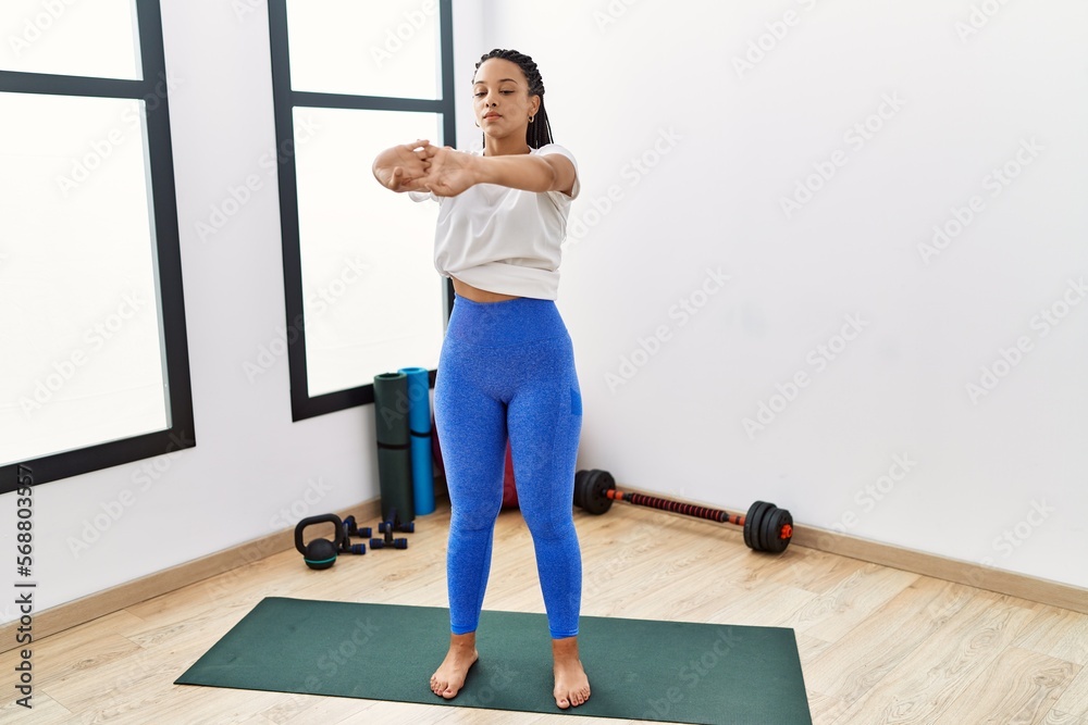 Young african american woman stretching at sport center Young african american woman stretching at sport center