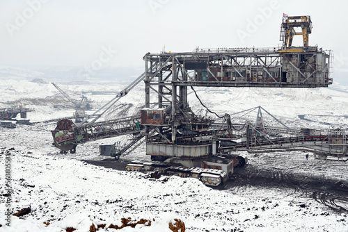 A huge excavator on a surface coal mine in winter conditions. Interesting appearance of surface mining under snow.