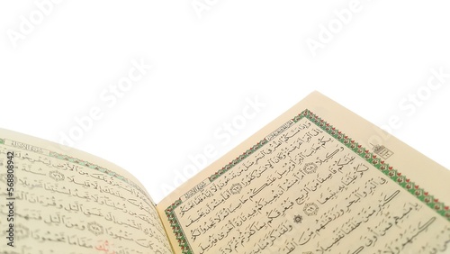 Open Quran pages with white background. Surah Al Baqarah. Arabic letters. Selective focus on letters. Al-Quran is a holy book of Islamic guidance isolated. Religion concept.