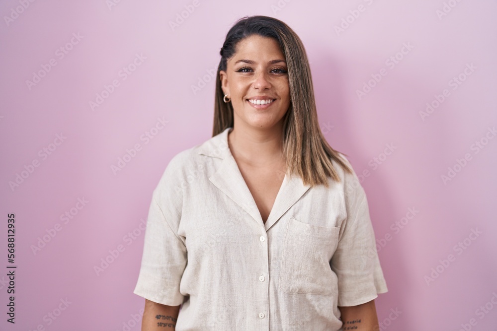 Blonde woman standing over pink background with a happy and cool smile on face. lucky person. Blonde woman standing over pink background with a happy and cool smile on face. lucky person.