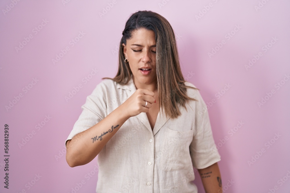 Blonde woman standing over pink background feeling unwell and coughing as symptom for cold or bronchitis. health care concept. Blonde woman standing over pink background feeling unwell and coughing as symptom for cold or bronchitis. health care concept.