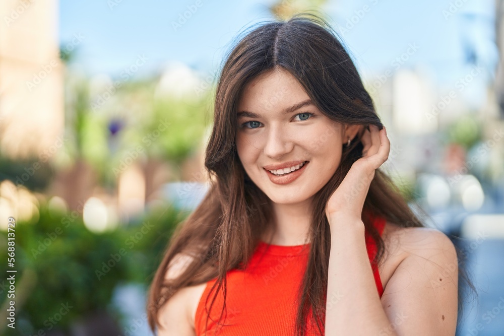 Young caucasian woman smiling confident standing at street