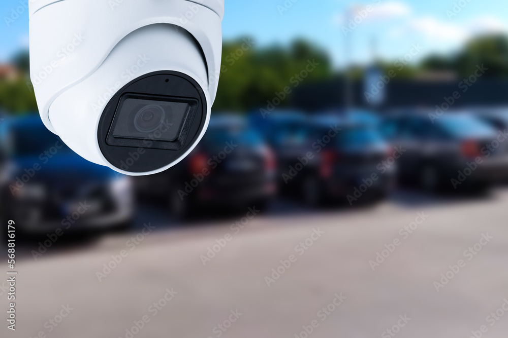 Closeup outdoor CCTV camera at a car parking lot.