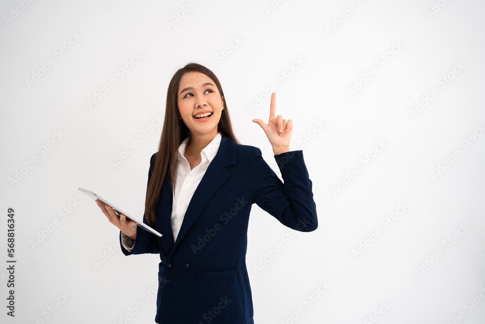 Young beautiful business woman pointing up at copyspace and looking at on pointing over isolated background cheerful with smile on face. Concept of advertising marketing and product placement concept