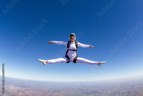 Beautiful woman skydiving in freefall, freestyle position.